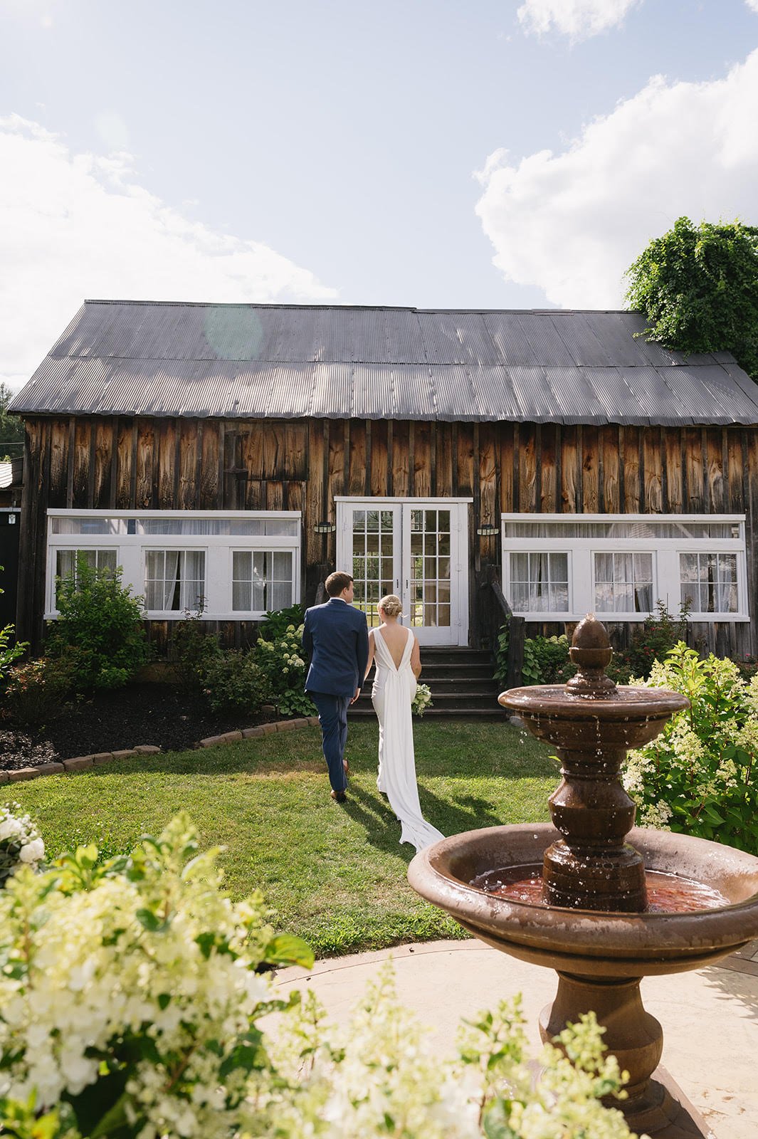 Couples in Front of Rustic Barn
